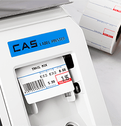 A CAS scale dispensing a printed label