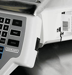 A Hobart scale dispensing a printed label