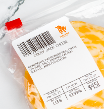 A bag of deli cheese with a scale label affixed to it