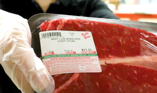 A closeup shot of a package of beef with a scale label affixed to it