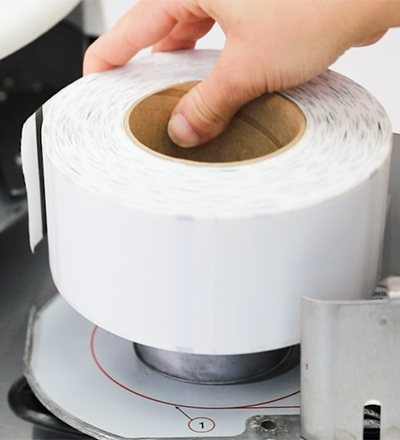 A roll of scale labels being placed into a machine