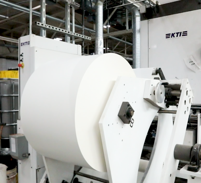 Label material flowing through a production facility