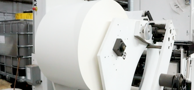 Label material flowing through a production facility