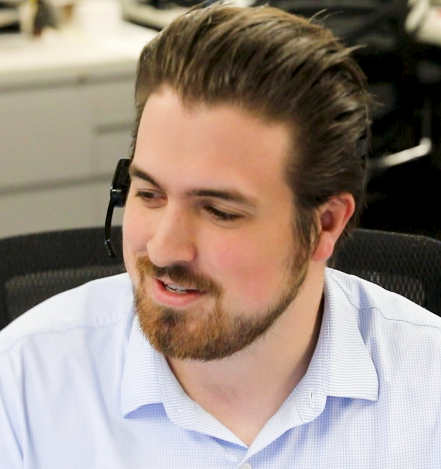 Sales associates speaking with customers through telephone headsets