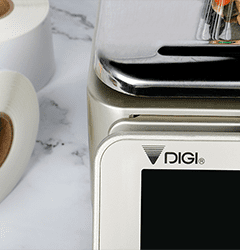 A DIGI scale dispensing a printed label