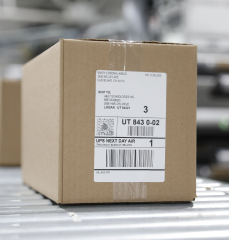 A sealed package rolling down a conveyor