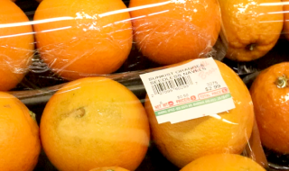 Packages of oranges with a produce label affixed to them
