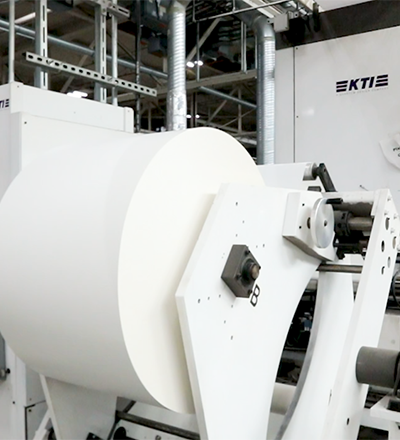 Label material flowing through a production facility