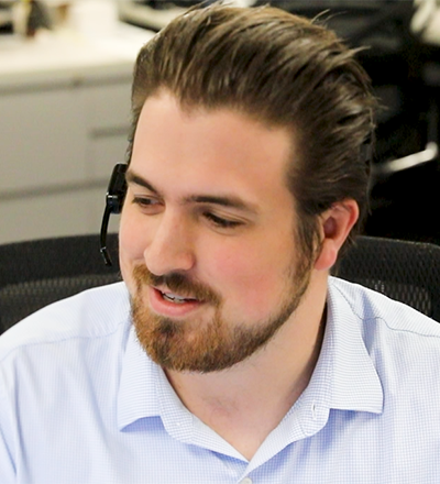 Sales associates speaking with customers through telephone headsets