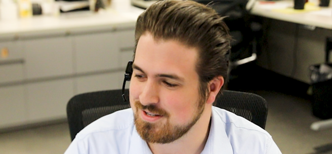 Sales associates speaking with customers through telephone headsets